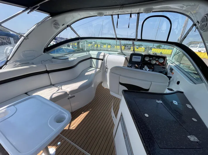  Yacht Photos Pics 2013 Rinker 310 Express Cruiser interior with seating, helm, and table.