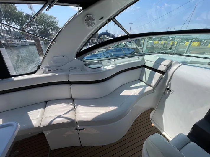  Yacht Photos Pics 2013 Rinker 310 Express Cruiser interior with white seating and wood flooring.
