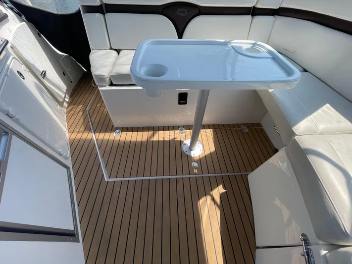  Yacht Photos Pics 2013 Rinker 310 Express Cruiser interior with white seating and wooden flooring.