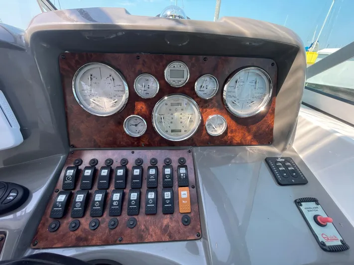  Yacht Photos Pics Control panel of a 2013 Rinker 310 Express Cruiser with gauges and switches.