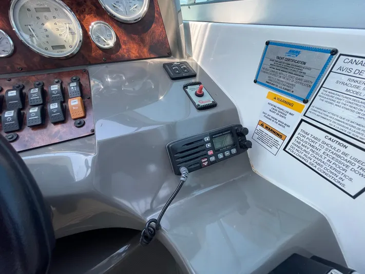  Yacht Photos Pics Control panel of a 2013 Rinker 310 Express Cruiser with gauges and warning labels.