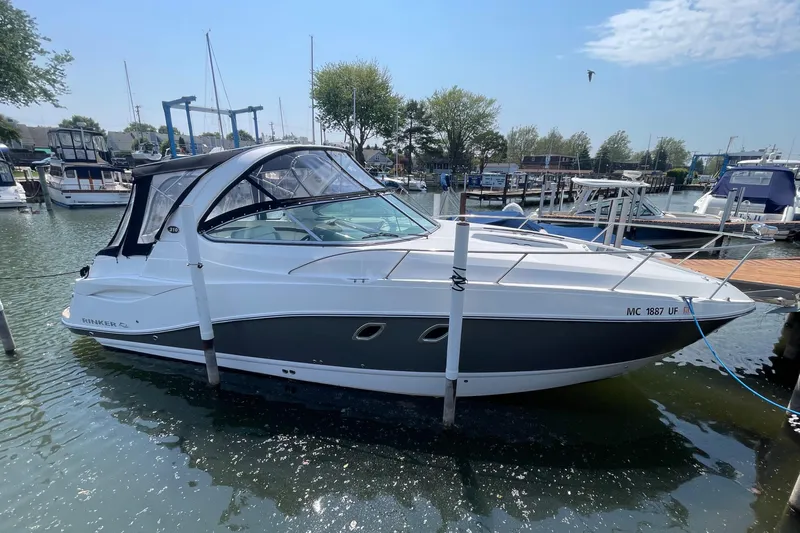  Yacht Photos Pics 2013 Rinker 310 Express Cruiser docked in a marina under a clear blue sky.
