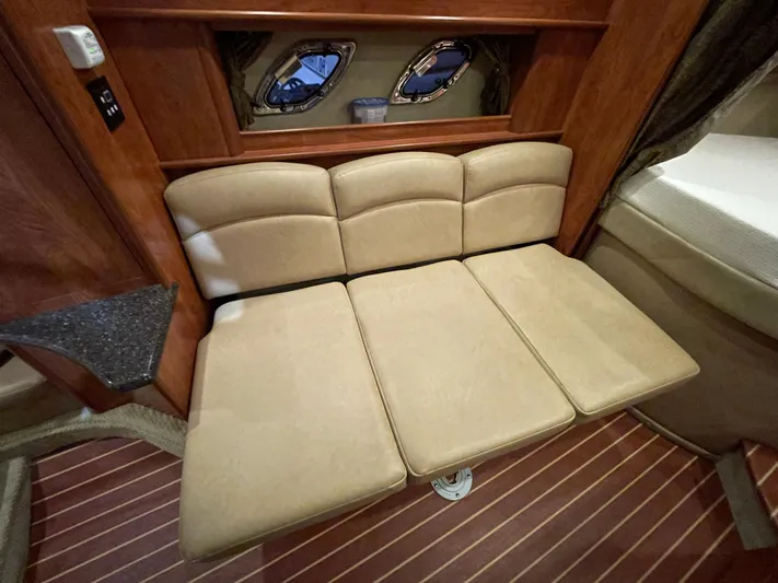  Yacht Photos Pics 2013 Rinker 310 Express Cruiser interior with beige seating and wooden accents.