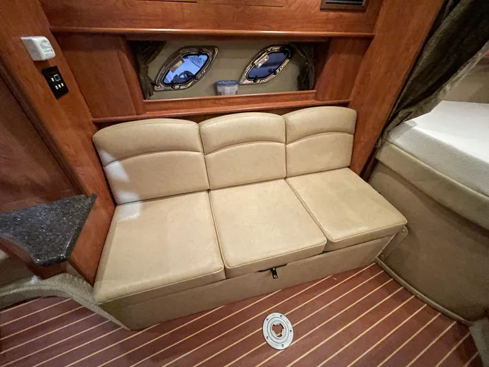  Yacht Photos Pics Interior of 2013 Rinker 310 Express Cruiser with beige seating and wooden accents.