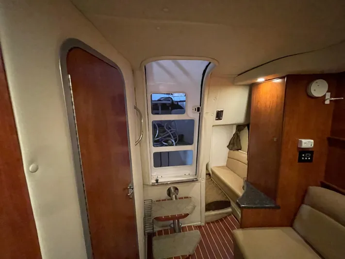  Yacht Photos Pics Interior of 2013 Rinker 310 Express Cruiser with seating and wooden cabinetry.