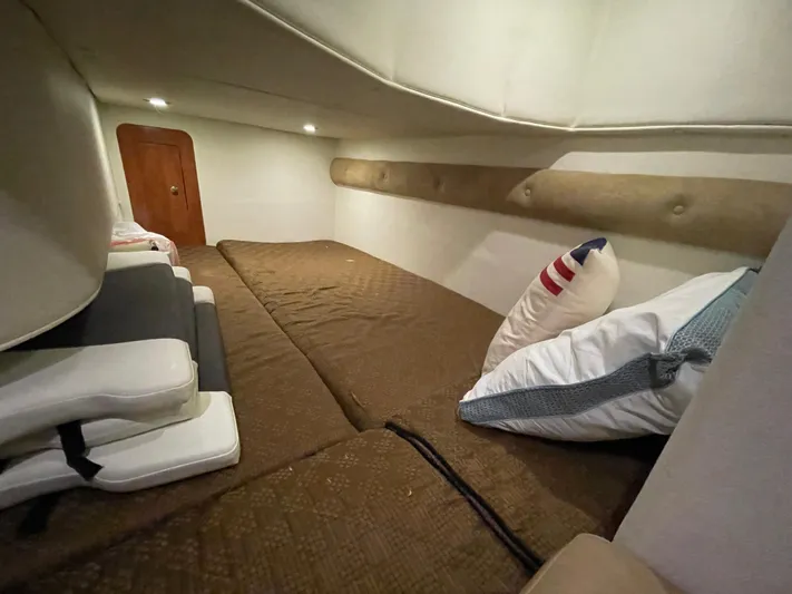  Yacht Photos Pics 2013 Rinker 310 Express Cruiser cabin interior with cozy bedding and cushions.