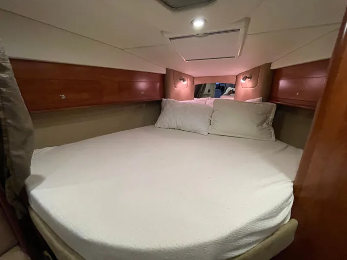  Yacht Photos Pics 2013 Rinker 310 Express Cruiser cabin with cozy bed and ambient lighting.
