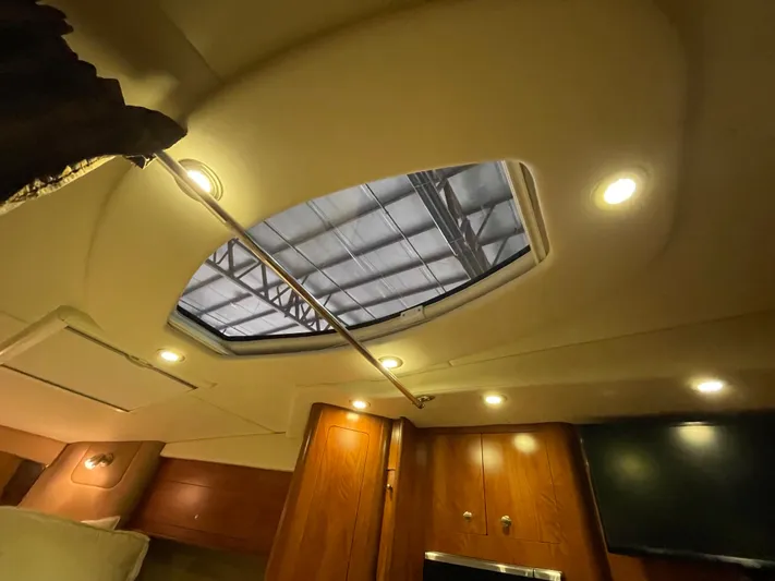  Yacht Photos Pics Interior view of 2013 Rinker 310 Express Cruiser with skylight and wooden cabinetry.