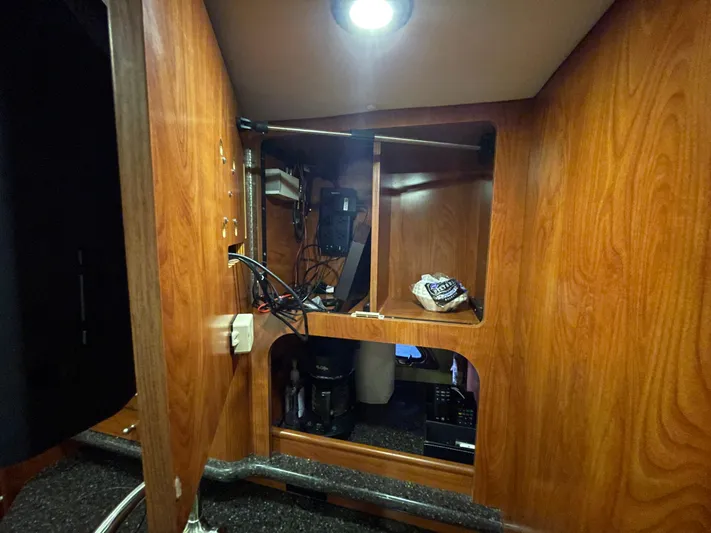  Yacht Photos Pics Interior of 2013 Rinker 310 Express Cruiser with wooden cabinetry and storage space.