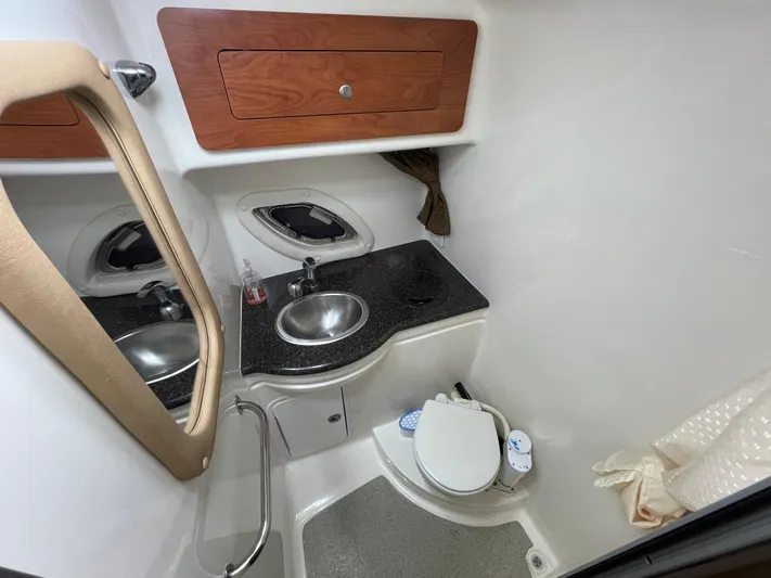  Yacht Photos Pics 2013 Rinker 310 Express Cruiser bathroom with sink, mirror, and toilet.