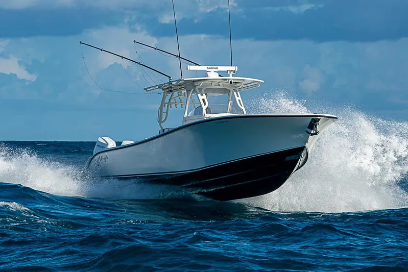 Quest Yacht Photos Pics 2011 Yellowfin 39 Offshore boat navigating ocean waves under cloudy sky.