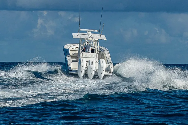 Quest Yacht Photos Pics 2011 Yellowfin 39 Offshore boat navigating ocean waves, rear view.