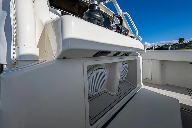 Quest Yacht Photos Pics 2011 Yellowfin 39 Offshore boat console with speakers and controls, under clear blue sky.
