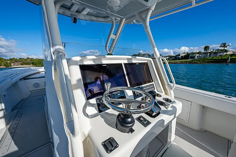 Quest Yacht Photos Pics 2011 Yellowfin 39 Offshore boat helm with dual screens and steering wheel on open water.