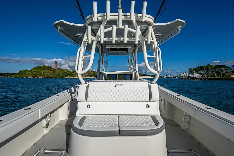 Quest Yacht Photos Pics 2011 Yellowfin 39 Offshore boat interior with seating, ocean view, and clear blue sky.