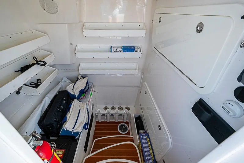 Quest Yacht Photos Pics 2011 Yellowfin 39 Offshore boat interior storage area with shelves and equipment.