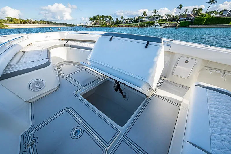 Quest Yacht Photos Pics 2011 Yellowfin 39 Offshore boat interior with open storage, seating, and scenic waterfront view.