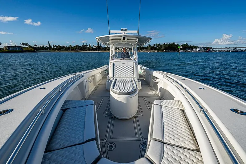 Quest Yacht Photos Pics 2011 Yellowfin 39 Offshore boat on calm water, featuring spacious seating and sleek design.