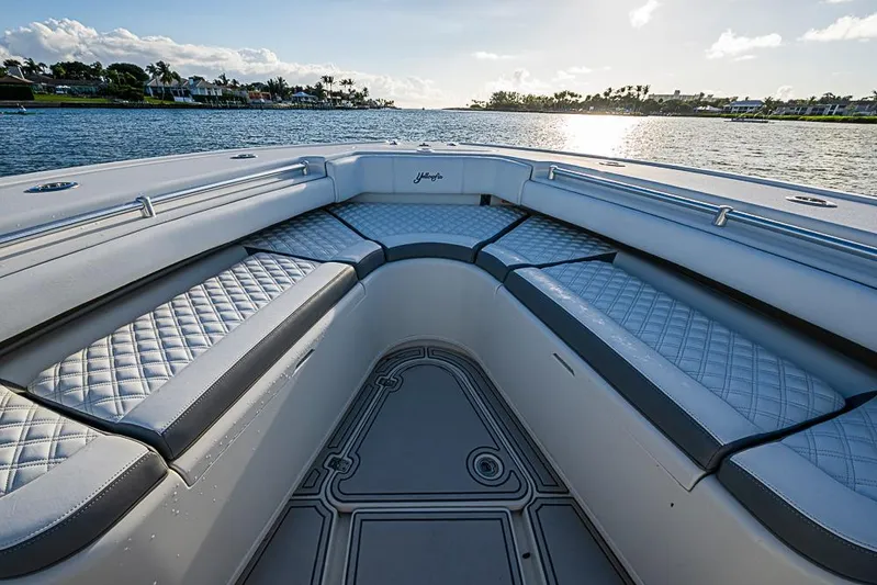 Quest Yacht Photos Pics 2011 Yellowfin 39 Offshore boat interior with cushioned seating, overlooking serene water.