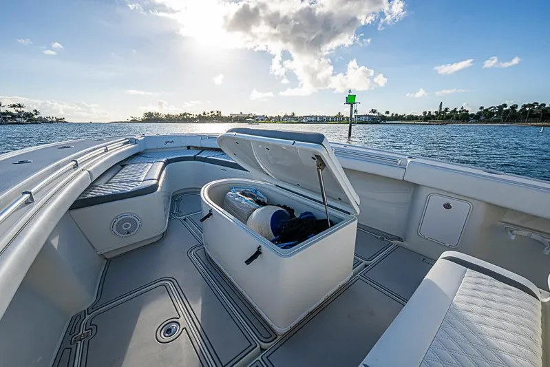 Quest Yacht Photos Pics 2011 Yellowfin 39 Offshore boat interior with open storage, on calm water under blue sky.
