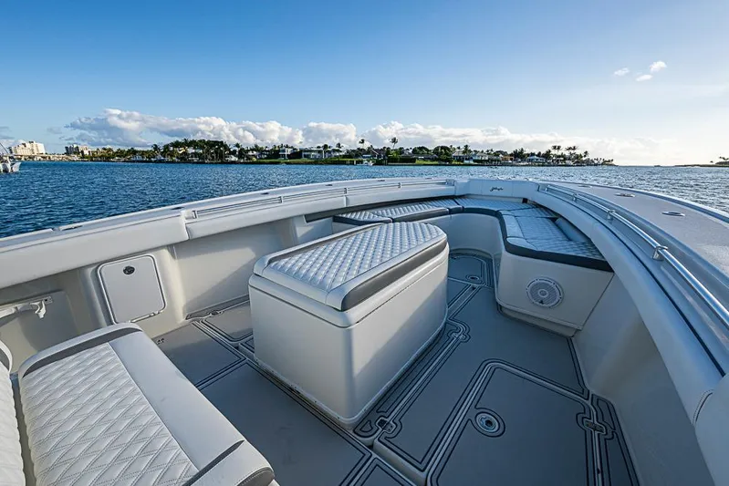 Quest Yacht Photos Pics 2011 Yellowfin 39 Offshore boat interior with cushioned seating, ocean view, and clear sky.