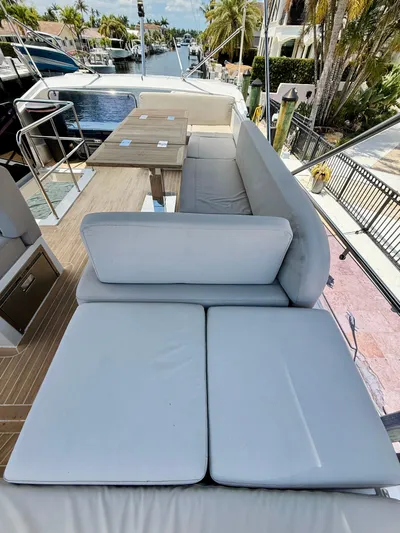La Vida Boca Yacht Photos Pics 2019 Sealine F430 yacht deck with cushioned seating and dining area, overlooking waterfront.