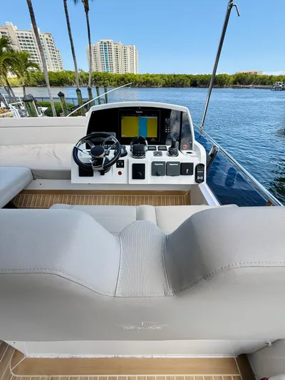 La Vida Boca Yacht Photos Pics 2019 Sealine F430 yacht helm with modern controls, overlooking serene waterfront and cityscape.