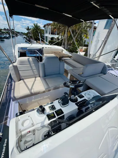 La Vida Boca Yacht Photos Pics 2019 Sealine F430 yacht with spacious deck and modern controls, docked by waterfront homes.
