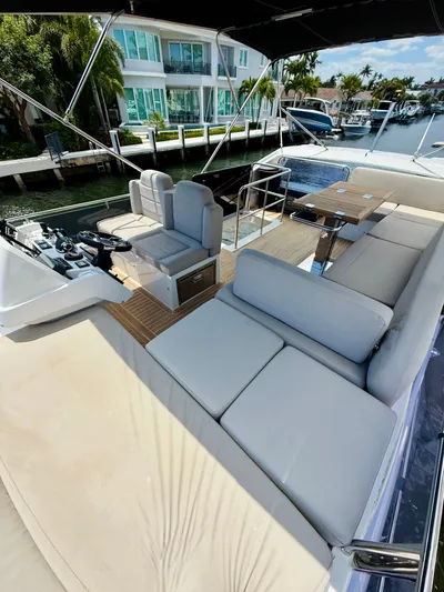 La Vida Boca Yacht Photos Pics 2019 Sealine F430 yacht with spacious outdoor seating and dining area, docked by waterfront homes.