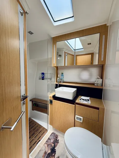 La Vida Boca Yacht Photos Pics Luxurious bathroom in 2019 Sealine F430 yacht with modern fixtures and wood accents.