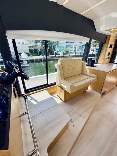 La Vida Boca Yacht Photos Pics 2019 Sealine F430 yacht interior with helm, beige seating, and large windows.