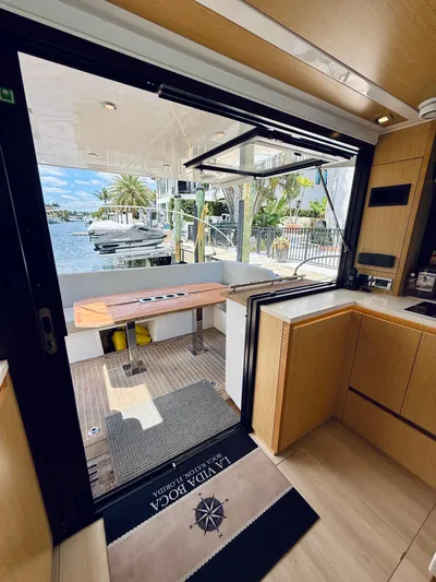 La Vida Boca Yacht Photos Pics Interior view of 2019 Sealine F430 yacht, featuring modern kitchen and open deck with waterfront view.