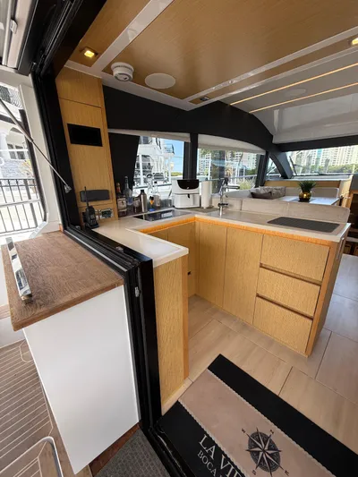 La Vida Boca Yacht Photos Pics Modern kitchen interior of 2019 Sealine F430 yacht with sleek wood finishes.