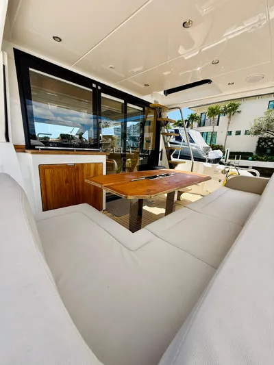 La Vida Boca Yacht Photos Pics 2019 Sealine F430 yacht interior with plush seating and wooden table.