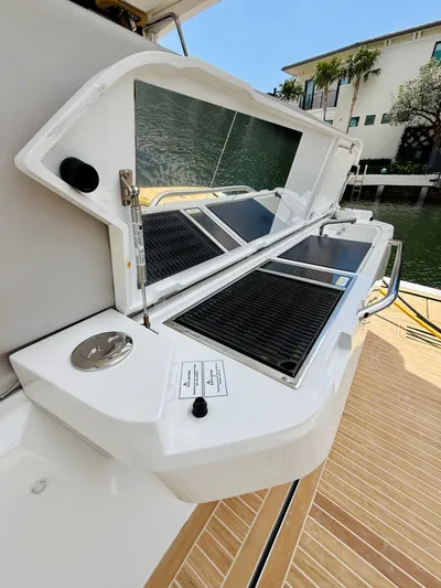 La Vida Boca Yacht Photos Pics 2019 Sealine F430 yacht outdoor kitchen with grill and sink, docked by waterfront.