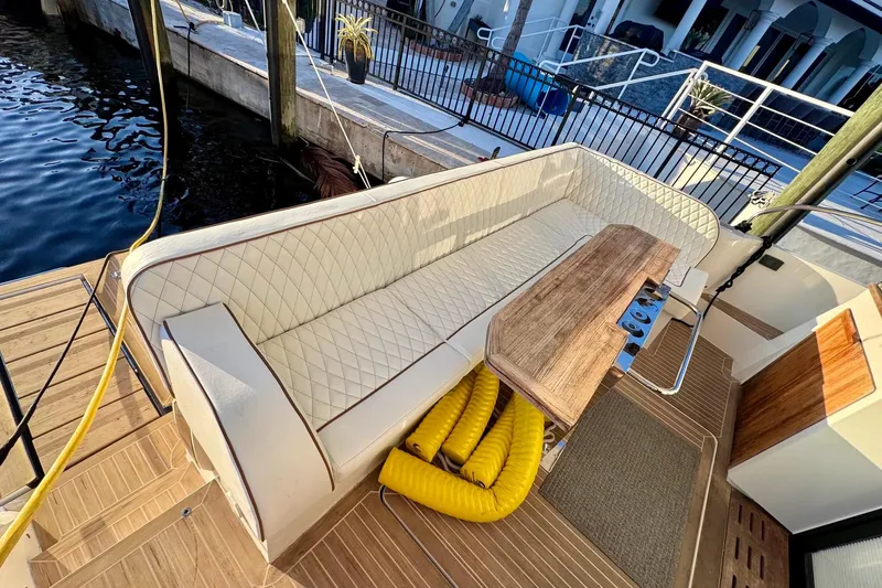 La Vida Boca Yacht Photos Pics Luxurious seating area on a 2019 Sealine F430 yacht with wooden table.