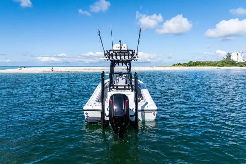  Yacht Photos Pics 2020 Barker Boatworks 26 Open on water near sandy beach, clear blue sky.