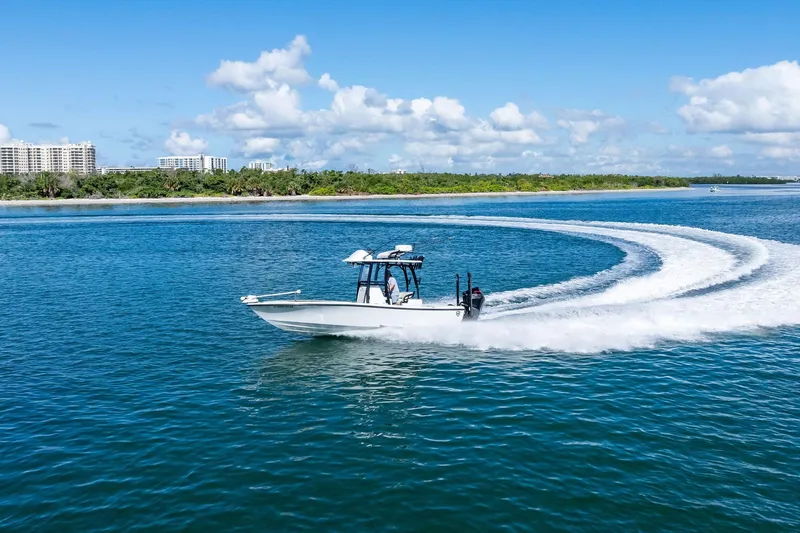  Yacht Photos Pics 2020 Barker Boatworks 26 Open cruising on blue water with scenic shoreline backdrop.