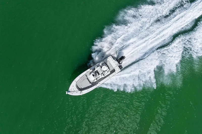  Yacht Photos Pics Aerial view of 2020 Barker Boatworks 26 Open speeding on green water.