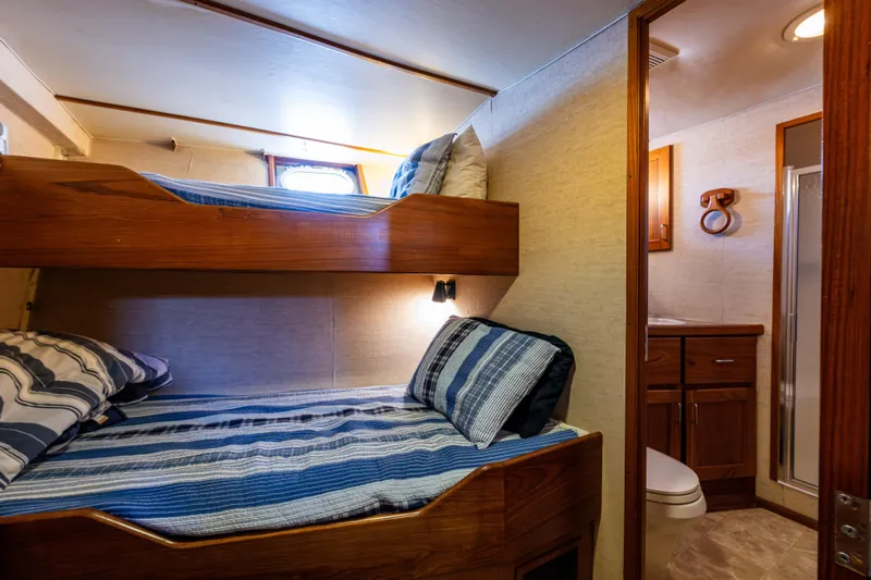 Traveller II Yacht Photos Pics Cozy 2001 Rodriquez Pilothouse cabin with bunk beds and adjacent bathroom.