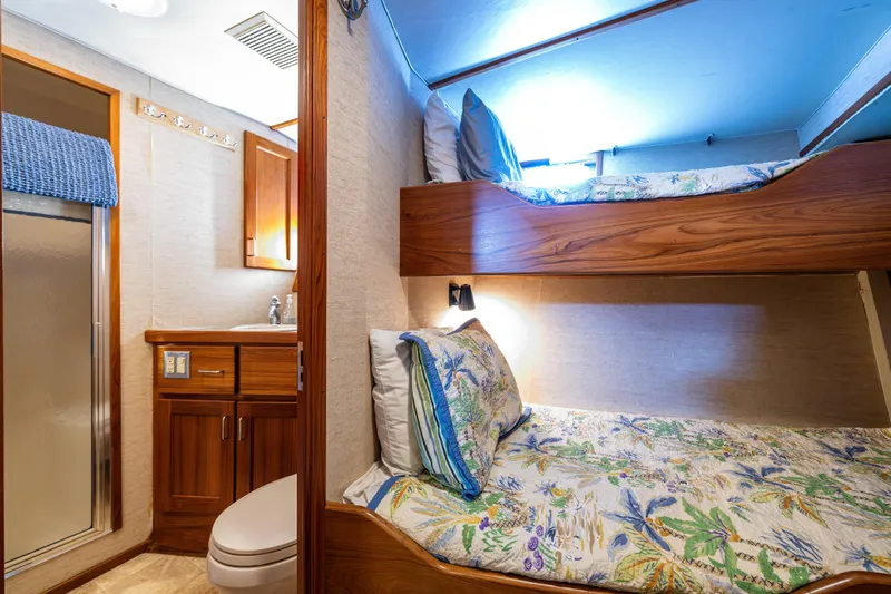 Traveller II Yacht Photos Pics Cozy 2001 Rodriquez Pilothouse cabin with bunk beds and compact bathroom.