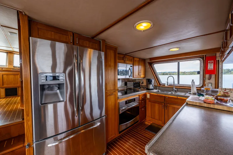 Traveller II Yacht Photos Pics Luxurious 2001 Rodriquez Pilothouse kitchen with stainless steel appliances and scenic window view.