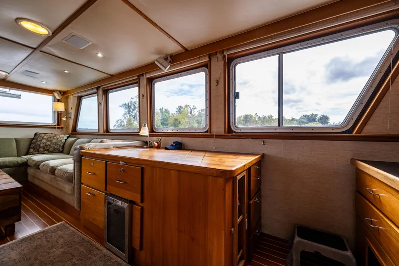 Traveller II Yacht Photos Pics Interior of 2001 Rodriquez Pilothouse boat with wooden cabinetry and large windows.