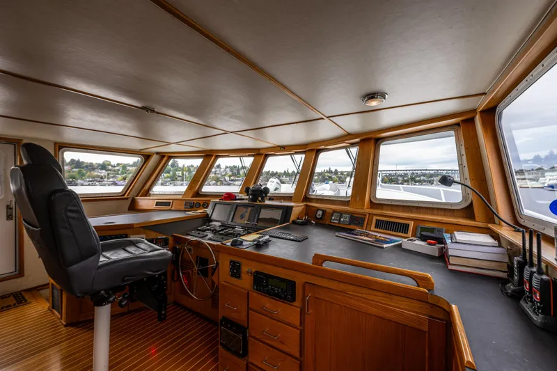 Traveller II Yacht Photos Pics Pilothouse interior of 2001 Rodriquez boat, featuring navigation equipment and panoramic windows.