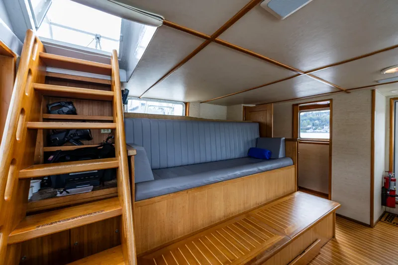Traveller II Yacht Photos Pics Interior of 2001 Rodriquez Pilothouse boat with wooden stairs and seating area.