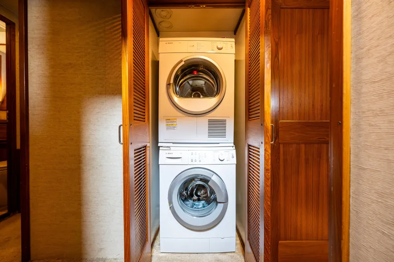 Traveller II Yacht Photos Pics Stacked washer and dryer in wooden closet on 2001 Rodriquez Pilothouse.