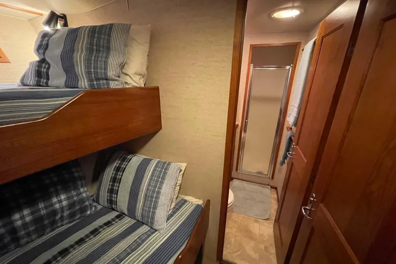 Traveller II Yacht Photos Pics Cozy 2001 Rodriquez Pilothouse interior with bunk beds and bathroom.