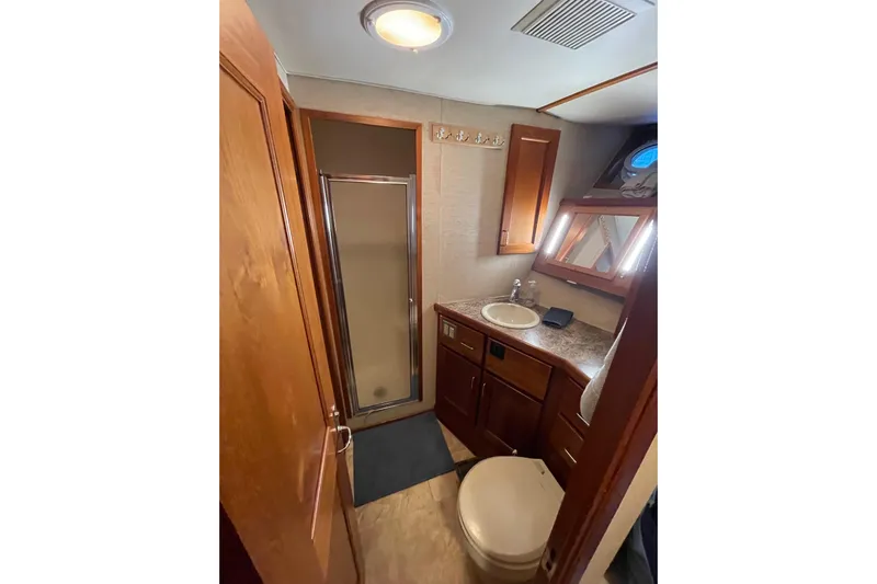 Traveller II Yacht Photos Pics Bathroom interior of 2001 Rodriquez Pilothouse yacht with shower and vanity.