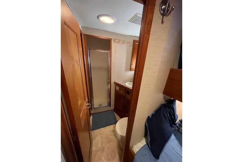 Traveller II Yacht Photos Pics Compact bathroom in 2001 Rodriquez Pilothouse with shower, sink, and toilet.