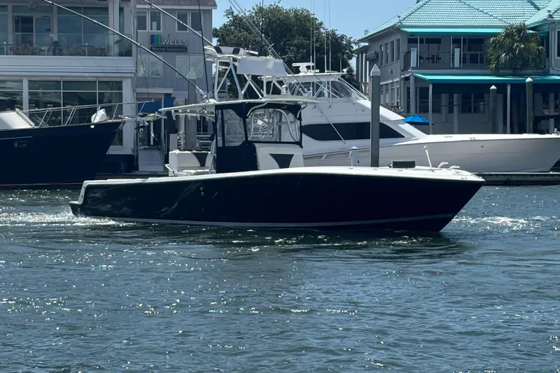  Yacht Photos Pics 2004 SeaVee 34 boat on water near marina, sunny day.